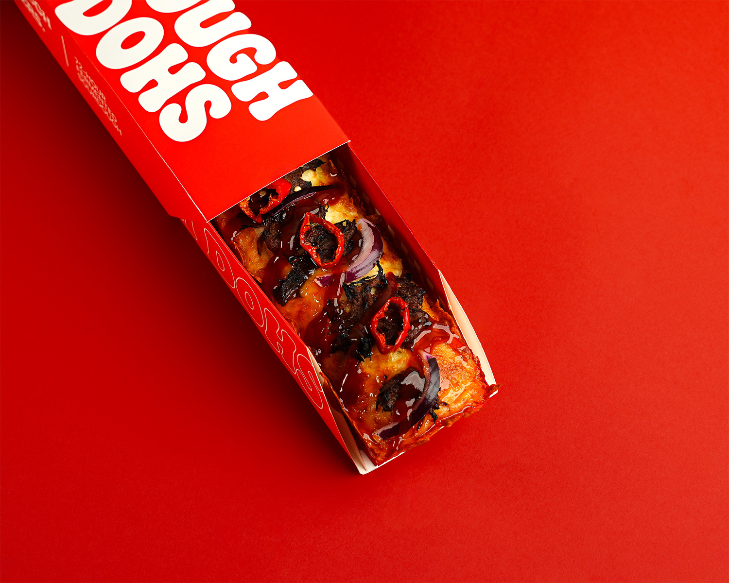 Dough Dohs The Rib pizza in its branded red box
