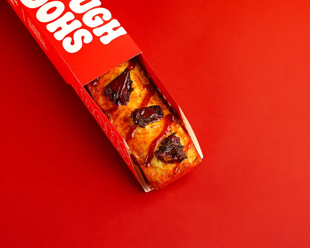 Dough Dohs Honey Brisket pizza in its branded red box